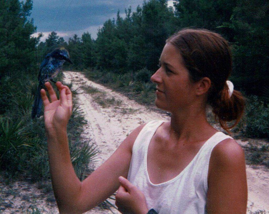 Pam with a Scrub Jay perched on her hand